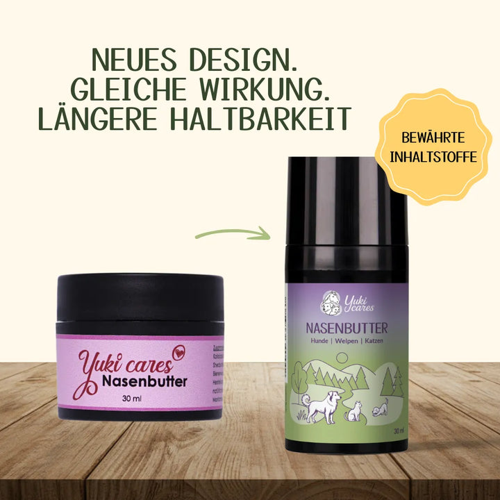 Zwei Verpackungen von Yuki cares Nasenbutter mit neuem Design und bewährten Inhaltsstoffen stehen auf einem Holztisch.