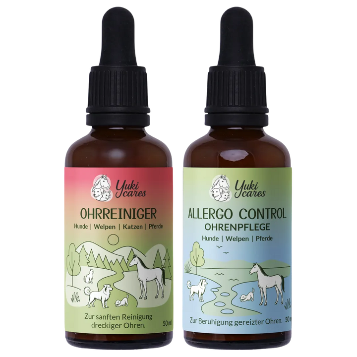 Zwei Flaschen Yuki Cares Ohrenpflegeprodukte für Tiere mit farbenfrohen Etiketten und Naturillustrationen stehen nebeneinander.