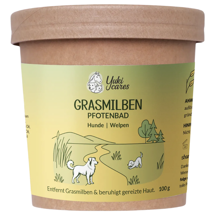 Ein Pfotenbad-Behälter für Hunde und Welpen mit einer Illustration von spielenden Hunden in einer grünen Landschaft.