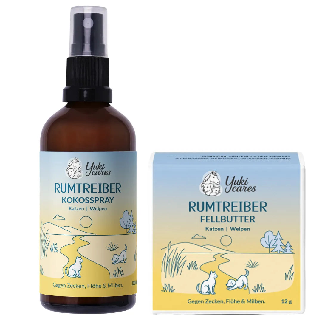 Ein Flakon mit Yuki cares Kokosspray und eine Box mit Fellbutter für Katzen und Welpen stehen auf einem sanften Hintergrund.