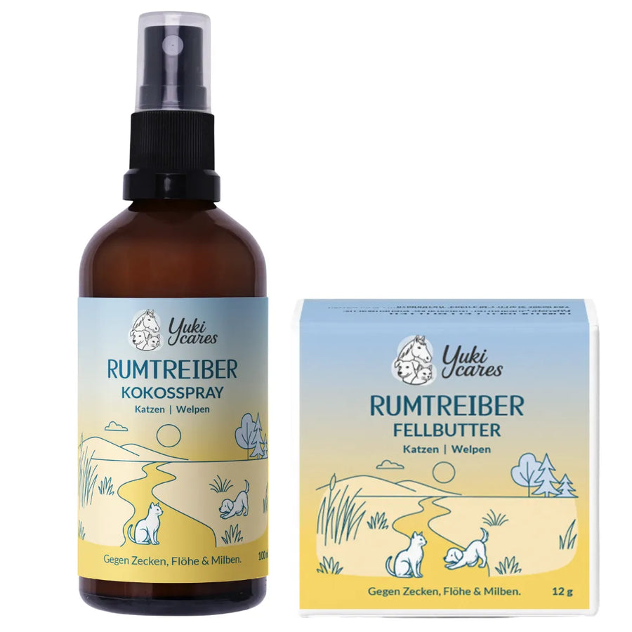 Ein Flakon mit Yuki cares Kokosspray und eine Box mit Fellbutter für Katzen und Welpen stehen auf einem sanften Hintergrund.